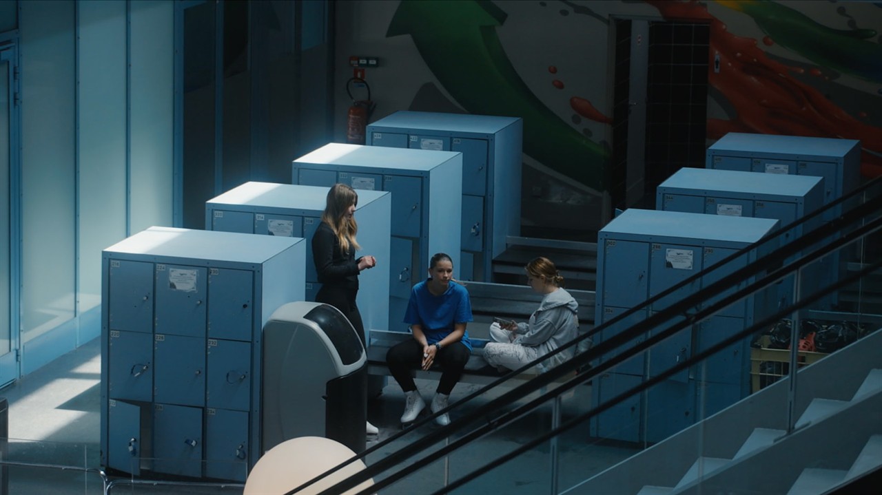 Teen girls sitting in a rink locker room